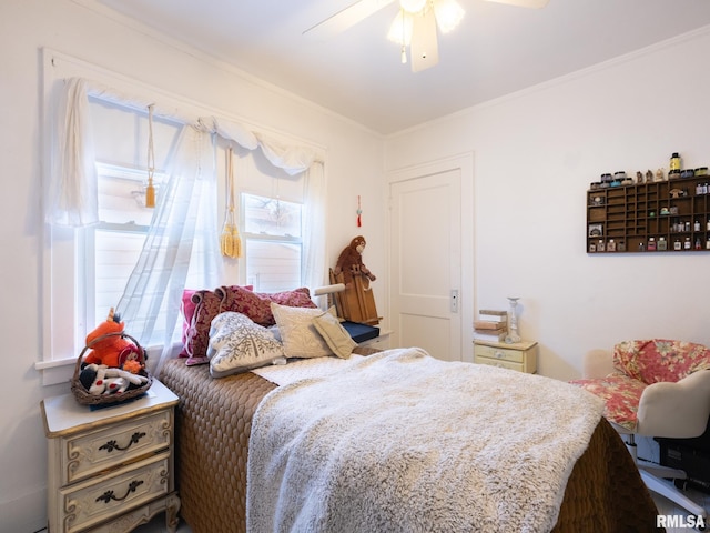 bedroom featuring ceiling fan, crown molding, and multiple windows