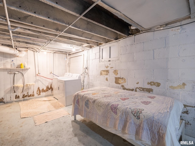 bedroom with washer and clothes dryer and concrete flooring