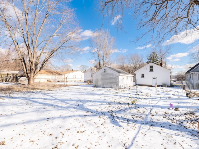 snowy yard with a storage unit