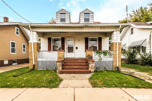 bungalow-style house with a front yard and a porch