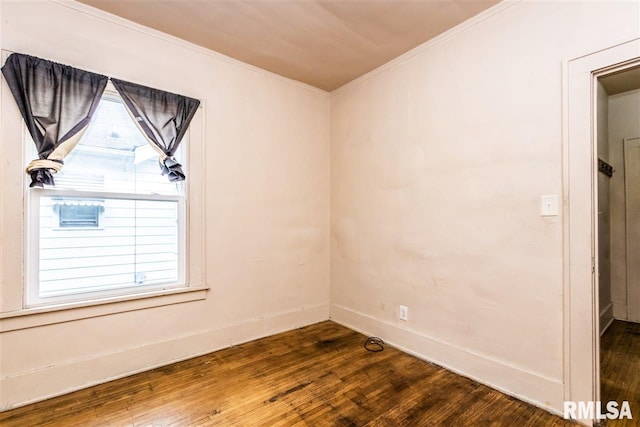 unfurnished room featuring dark hardwood / wood-style floors and ornamental molding