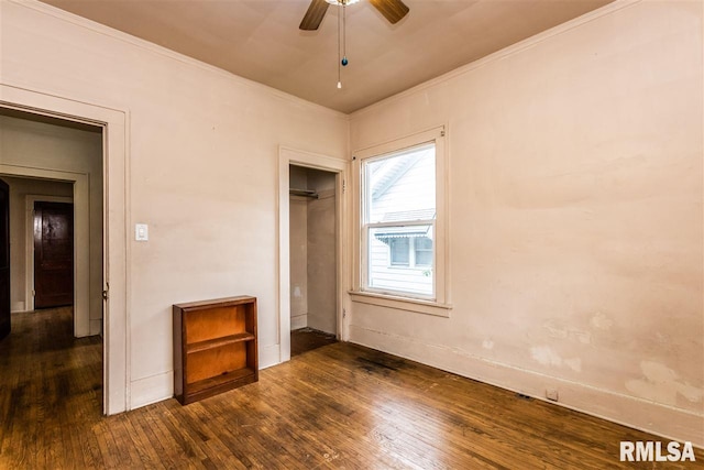 unfurnished bedroom with ceiling fan, dark hardwood / wood-style flooring, and a closet