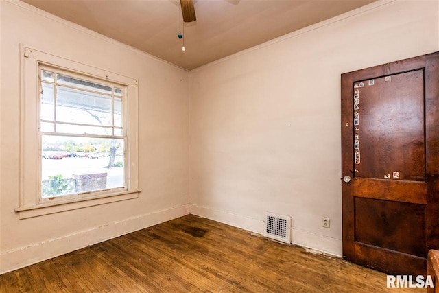 unfurnished room featuring ceiling fan, dark hardwood / wood-style flooring, and crown molding