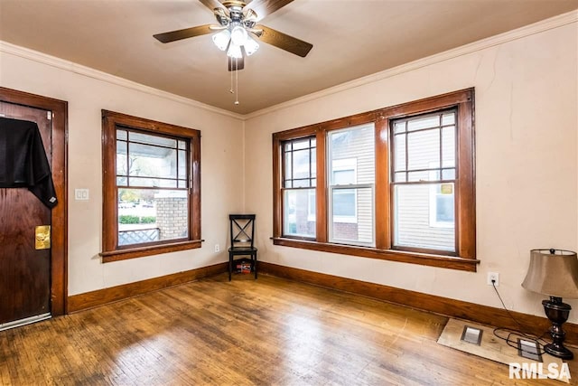 spare room with ceiling fan, crown molding, and hardwood / wood-style floors