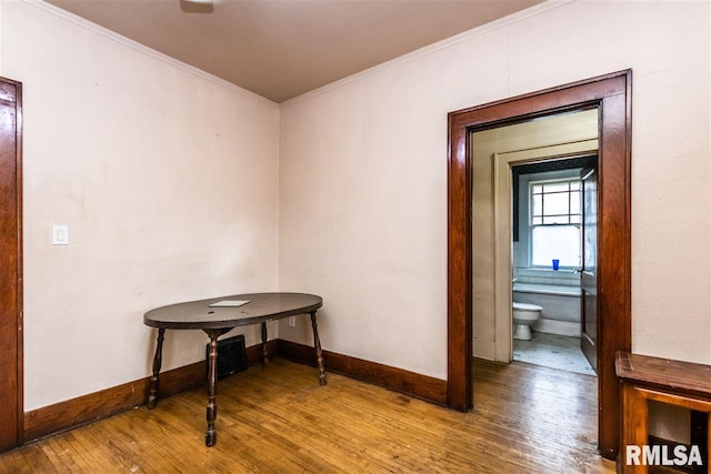 hall featuring wood-type flooring and ornamental molding