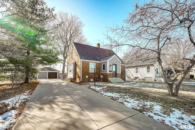 bungalow-style home featuring a garage and an outdoor structure