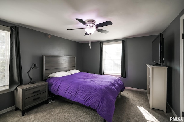 bedroom with ceiling fan and dark colored carpet