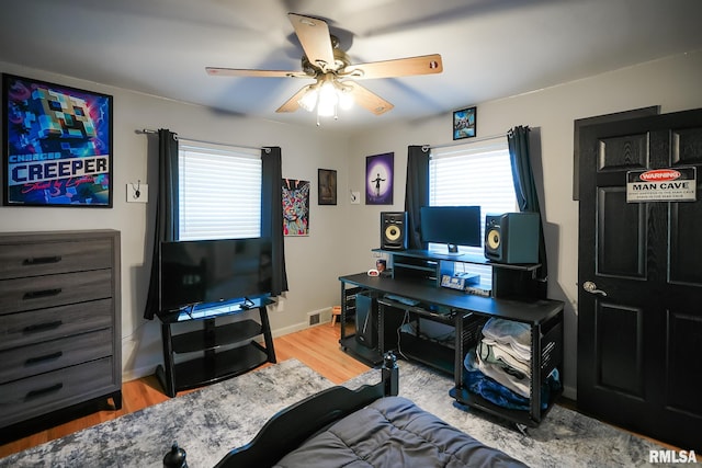 office space with ceiling fan and light hardwood / wood-style flooring