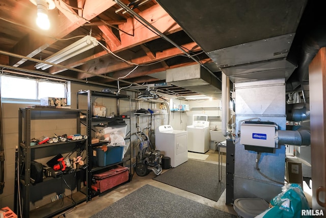 basement with independent washer and dryer and sink