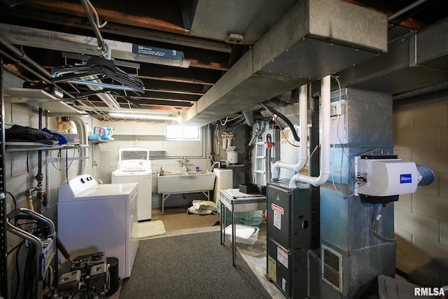 basement featuring independent washer and dryer and sink