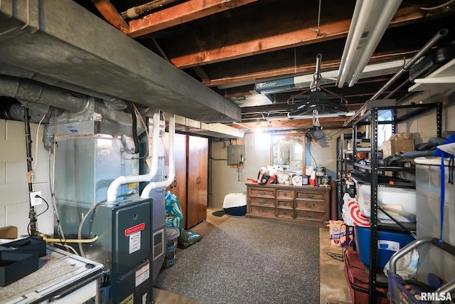 basement featuring electric panel and heating unit