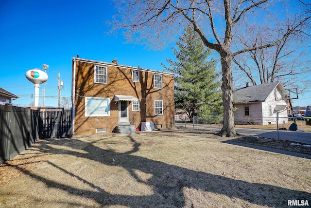 rear view of property with a lawn