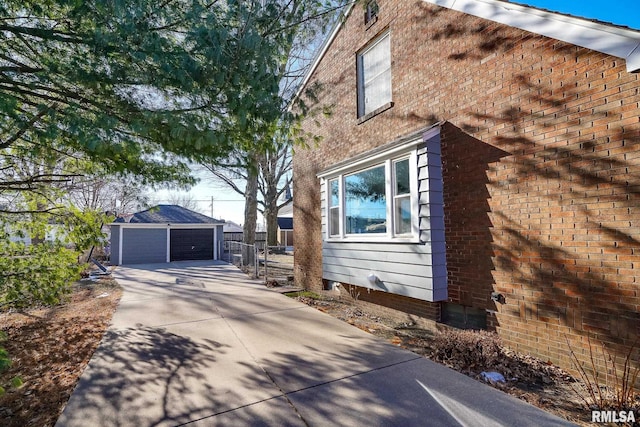 view of home's exterior with an outdoor structure and a garage