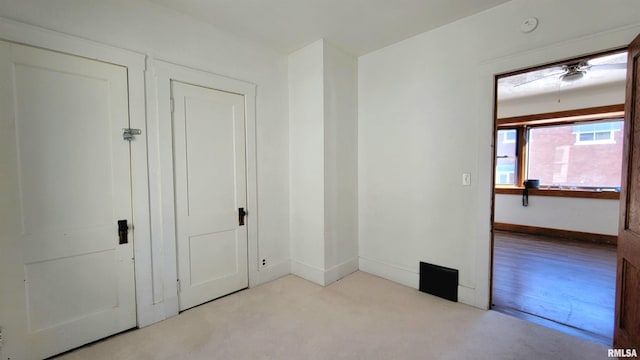 unfurnished room with light colored carpet