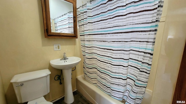 bathroom with toilet, shower / bath combo, and wood-type flooring