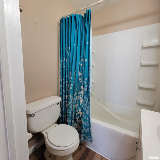 full bathroom featuring toilet, hardwood / wood-style flooring, vanity, and shower / tub combo with curtain