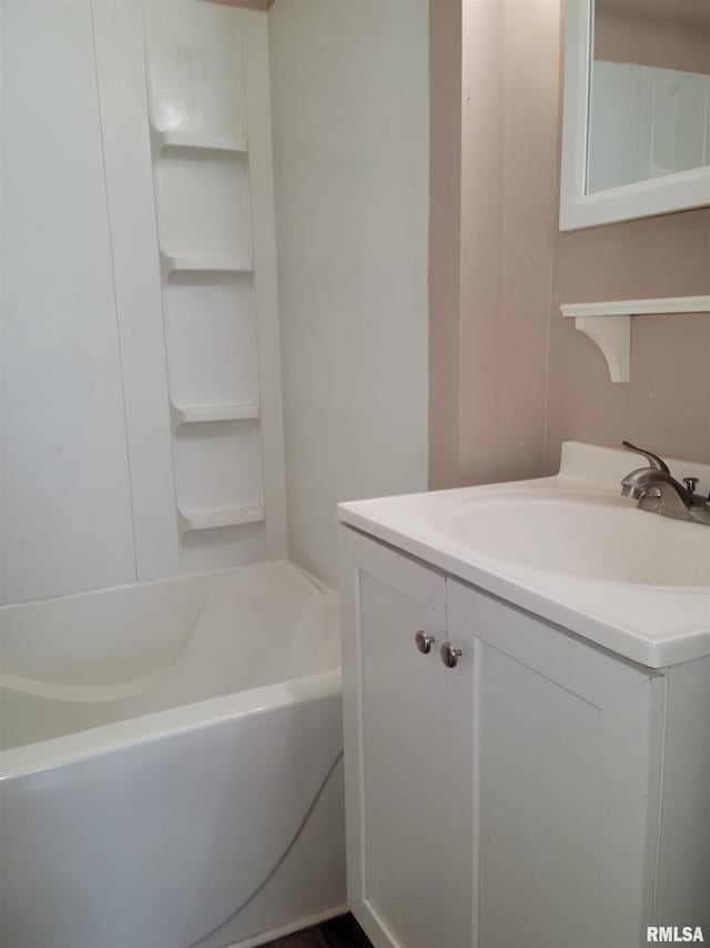 bathroom with a tub to relax in and vanity