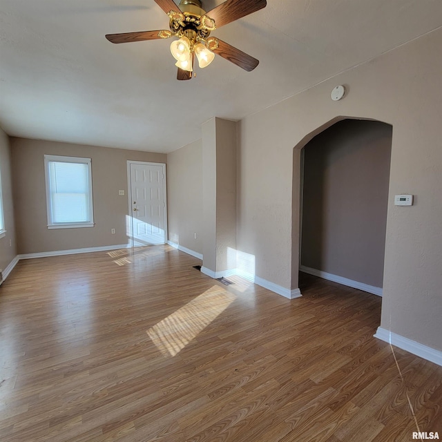 unfurnished room with ceiling fan and light wood-type flooring