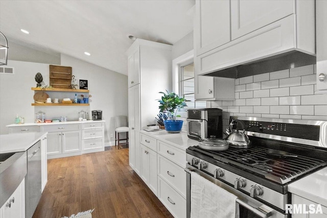 kitchen with vaulted ceiling, dark hardwood / wood-style floors, premium range hood, stainless steel appliances, and white cabinets