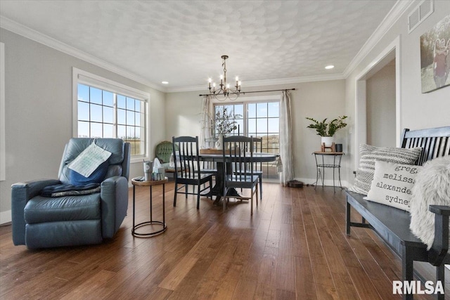 dining area with an inviting chandelier, crown molding, and dark hardwood / wood-style floors