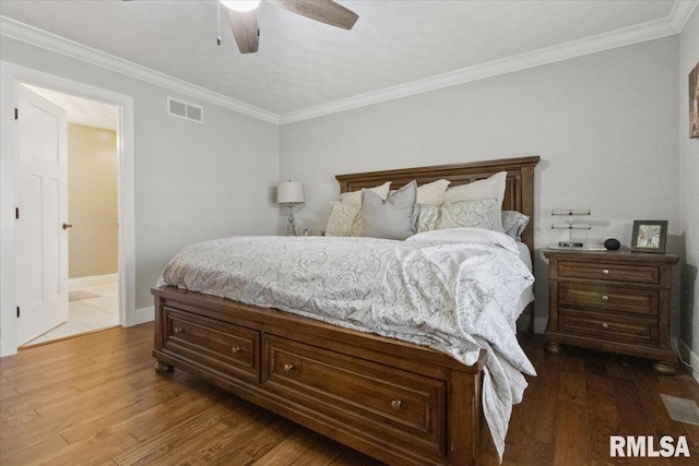 bedroom featuring ceiling fan, crown molding, and hardwood / wood-style floors