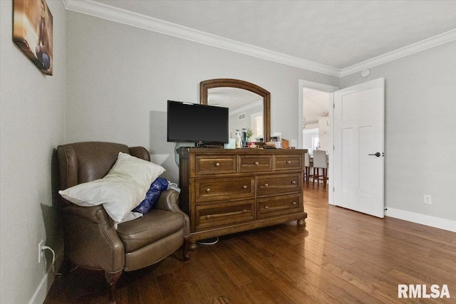 sitting room featuring dark hardwood / wood-style floors and crown molding