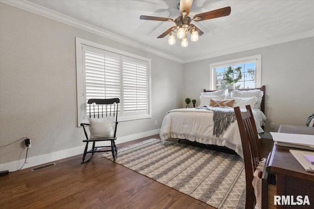 bedroom featuring dark wood-type flooring, ceiling fan, and crown molding