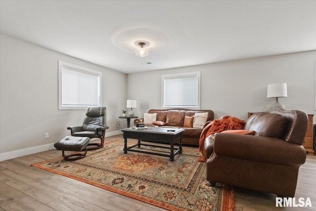 living room with plenty of natural light and hardwood / wood-style floors