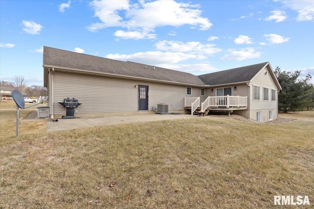 rear view of property with central AC, a yard, a patio area, and a wooden deck