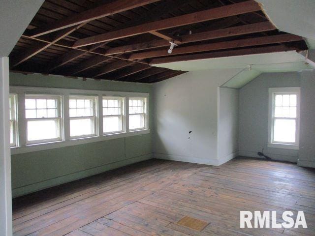 spare room with lofted ceiling and light hardwood / wood-style floors