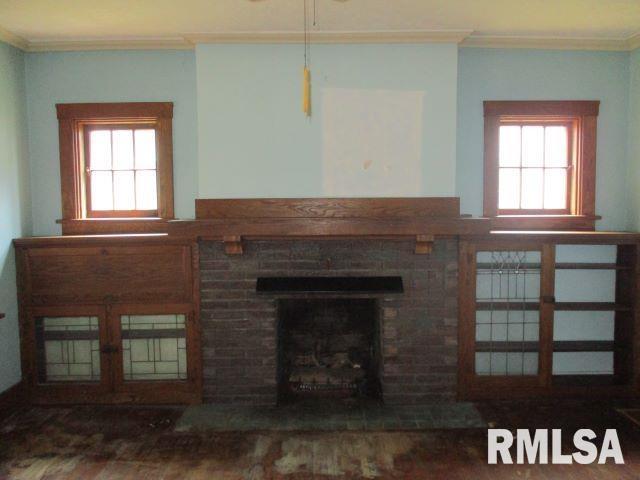 living room with crown molding and a wealth of natural light