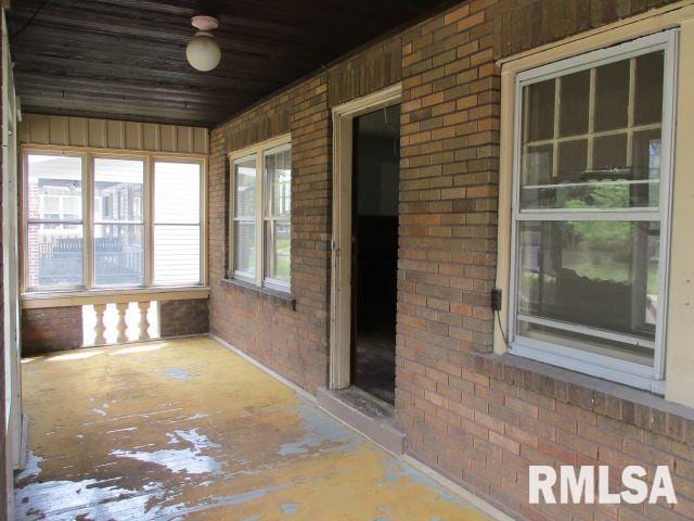 unfurnished sunroom with wooden ceiling