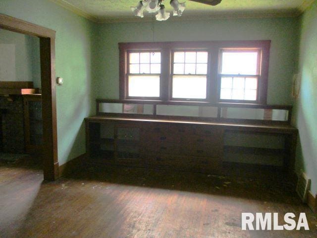 unfurnished room with hardwood / wood-style flooring, ornamental molding, and ceiling fan