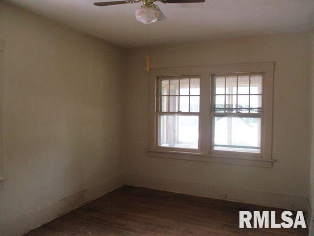 unfurnished room featuring ceiling fan and dark hardwood / wood-style flooring