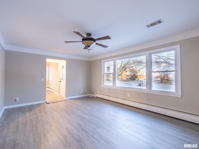 unfurnished room with baseboard heating, crown molding, and wood-type flooring