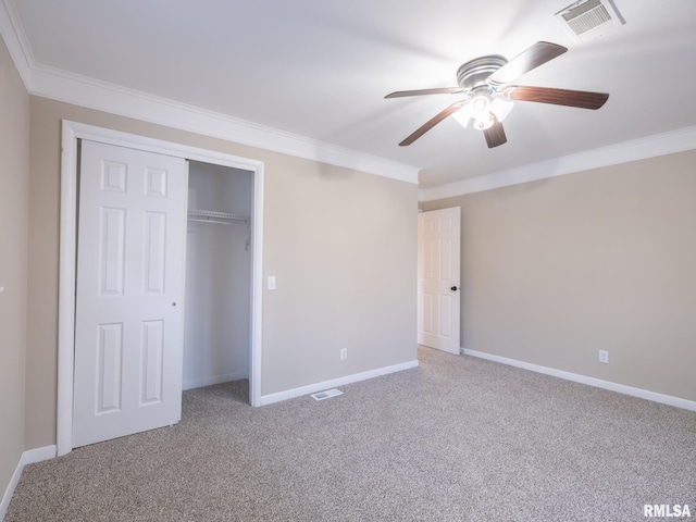 unfurnished bedroom with ceiling fan, a closet, carpet, and crown molding