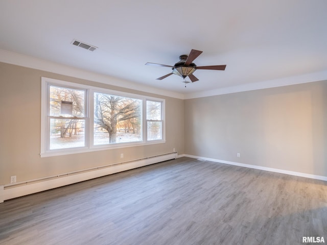 unfurnished room featuring ceiling fan, a baseboard radiator, wood-type flooring, and crown molding