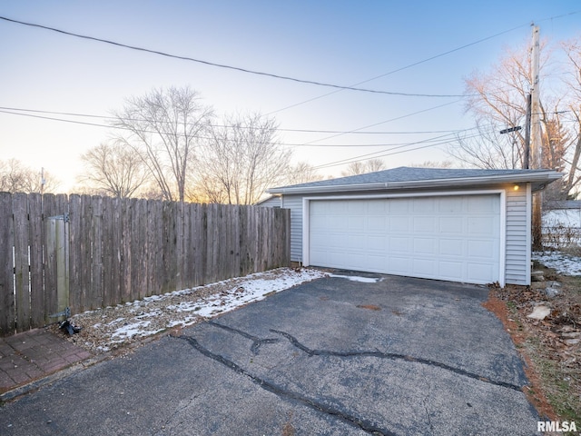 view of garage at dusk