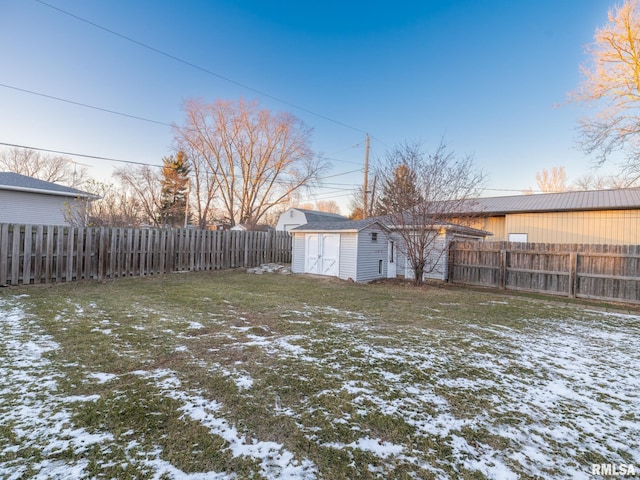 yard covered in snow with a storage unit