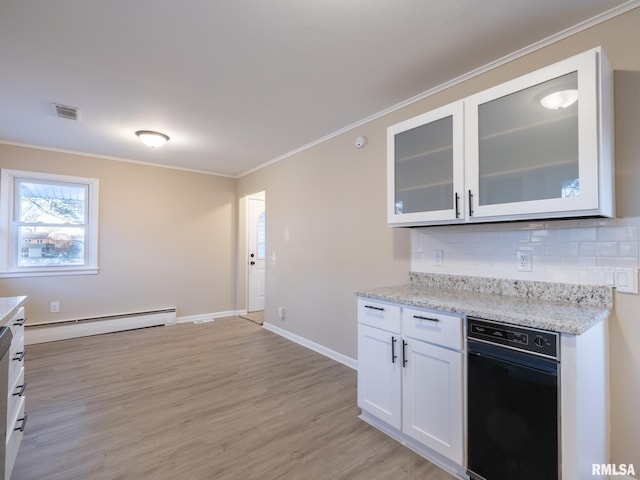 kitchen with light stone countertops, white cabinets, a baseboard heating unit, decorative backsplash, and light wood-type flooring