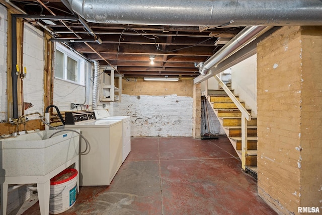 basement with sink and washer and dryer