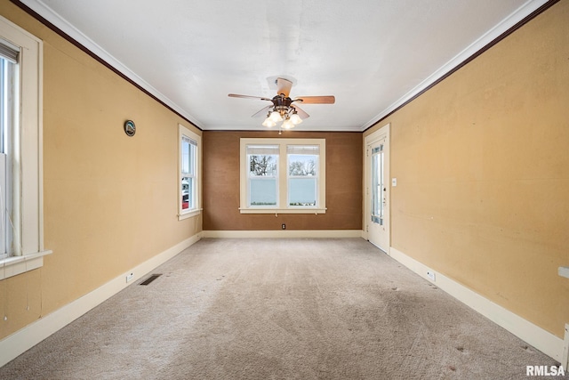 unfurnished room featuring ceiling fan, ornamental molding, and light colored carpet