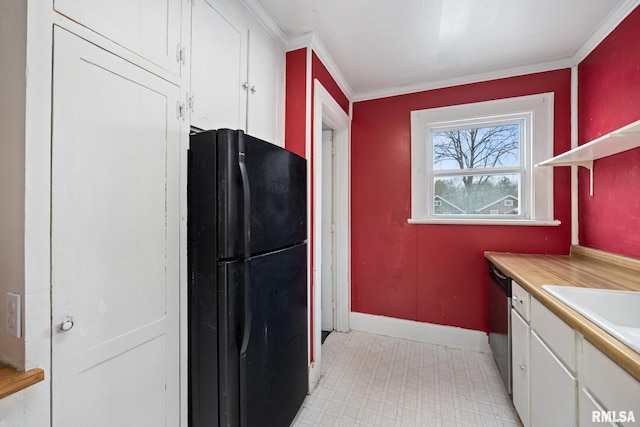 kitchen with black fridge, stainless steel dishwasher, sink, crown molding, and white cabinetry