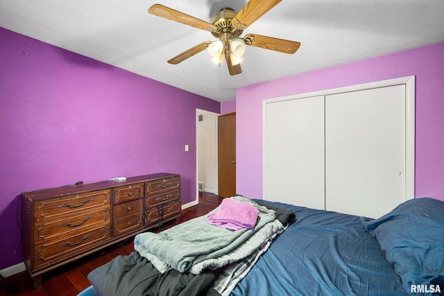 bedroom with ceiling fan, a closet, and dark hardwood / wood-style flooring