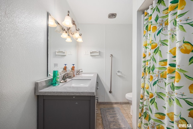 bathroom with toilet, walk in shower, and vanity