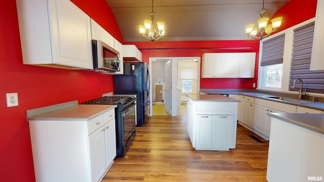 kitchen with a notable chandelier, white cabinetry, decorative light fixtures, and black appliances