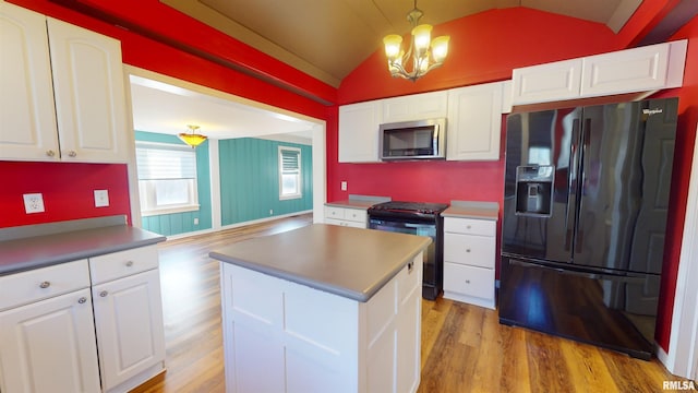 kitchen featuring black refrigerator with ice dispenser, gas range oven, white cabinets, and pendant lighting