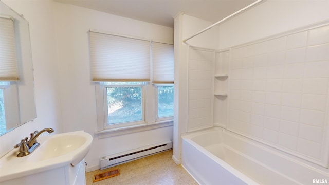 bathroom with a baseboard heating unit, vanity, and bathtub / shower combination