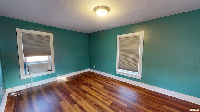 empty room with dark wood-type flooring