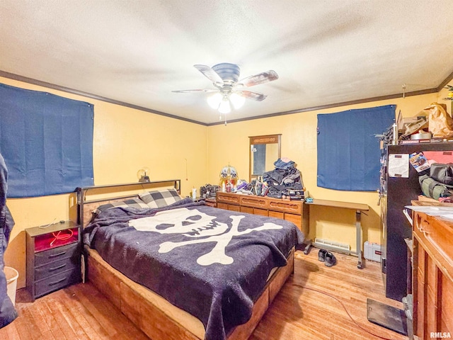 bedroom featuring ceiling fan, a textured ceiling, crown molding, and light wood-type flooring